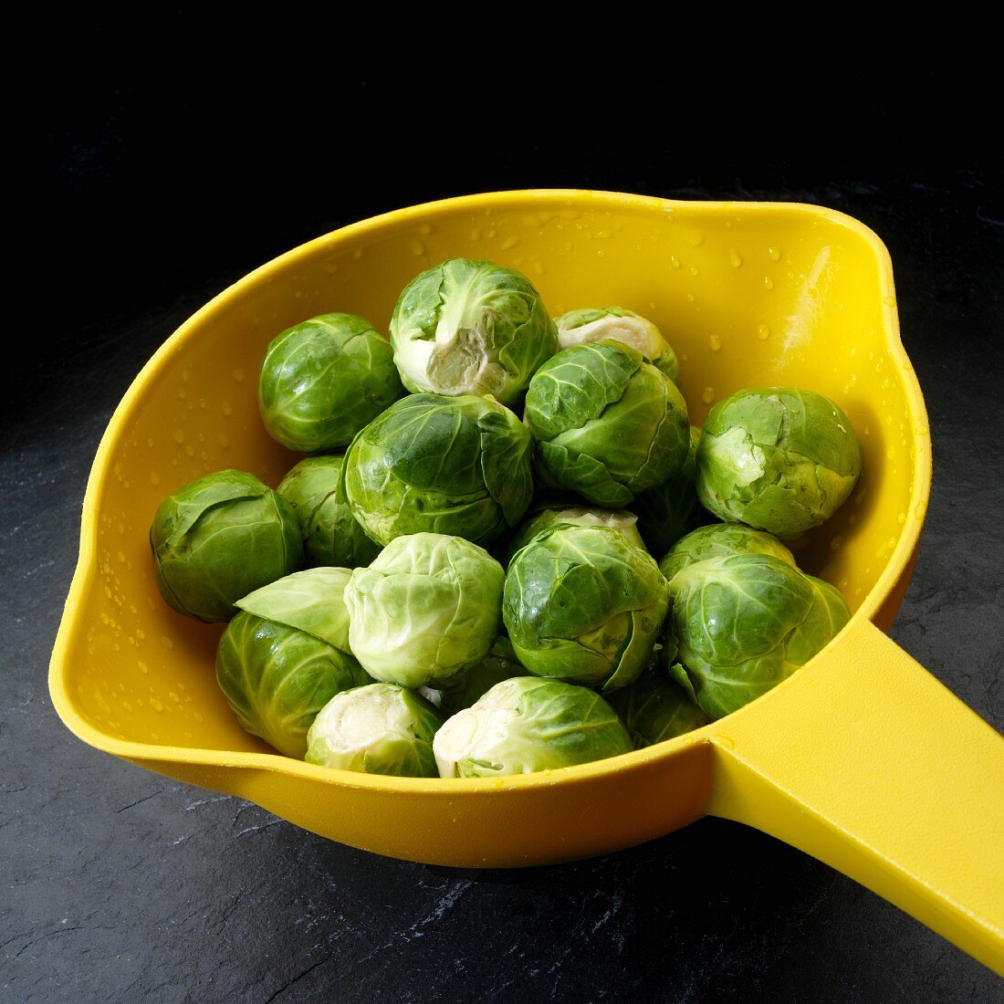 Brussels sprouts in yellow colander