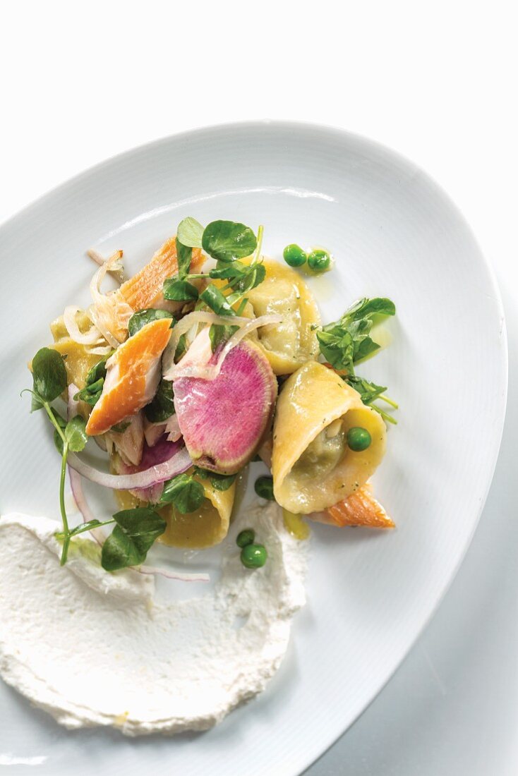 Smoked Trout Salad with Spring Pea Ravioli shot from above on white