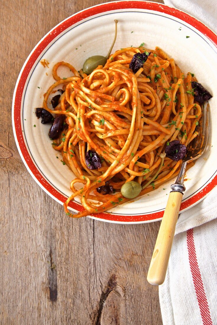 Noodles with tomato berserk, olives and capers (Italy)