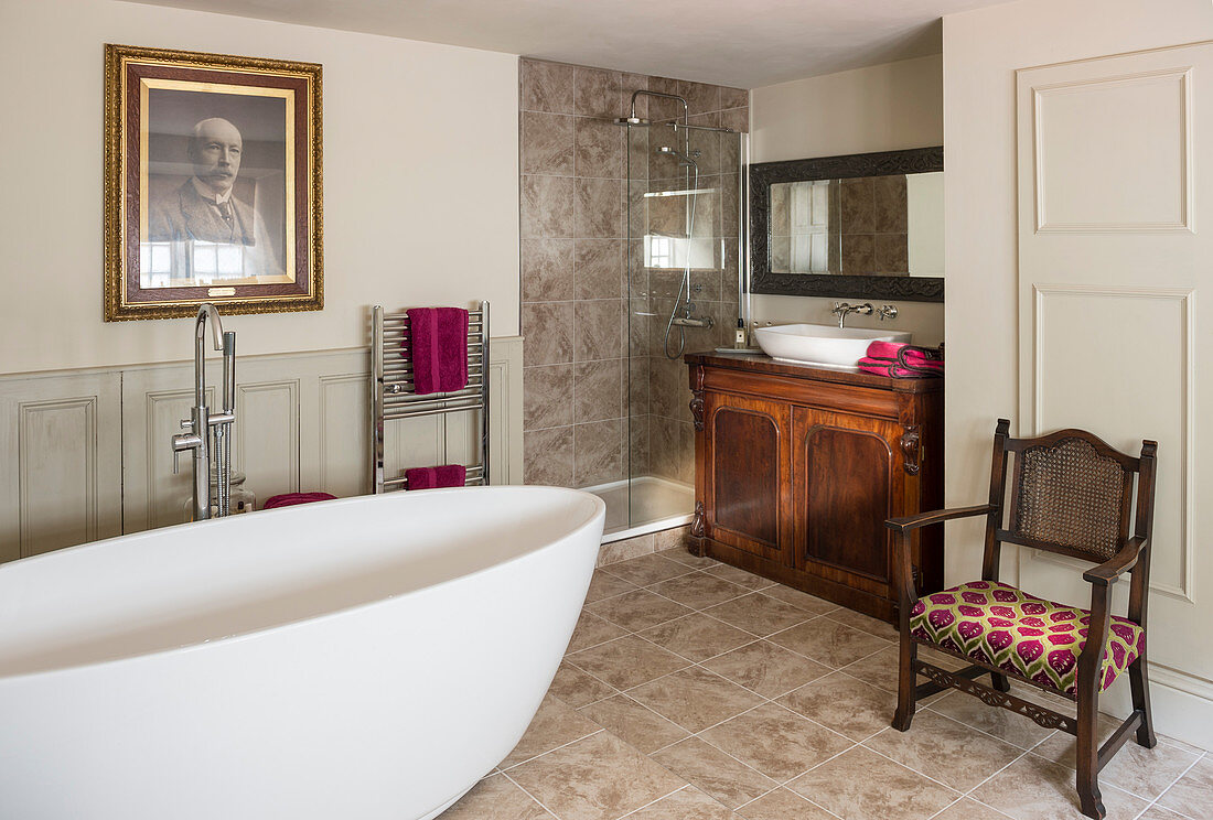 Modern, oval bathroom and antique furniture in bathroom