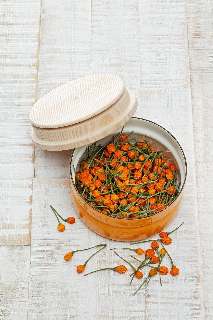 Dried yellow Charapita chillies in a tin