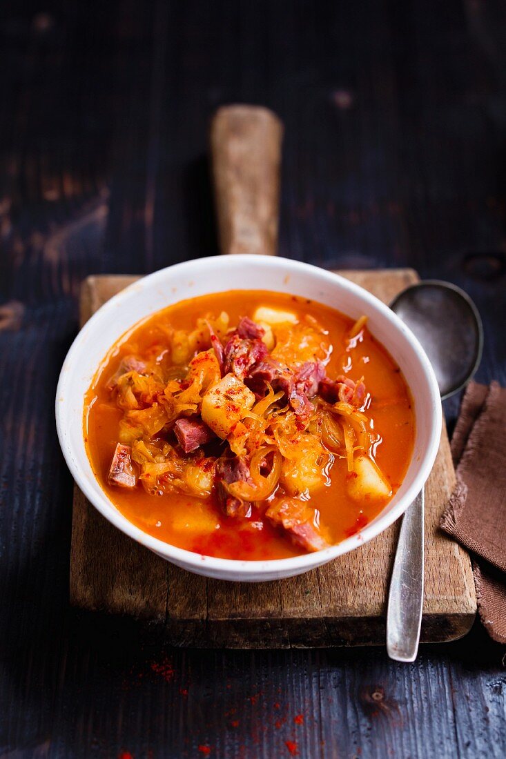 Sauerkraut soup with potatoes and pork sausages