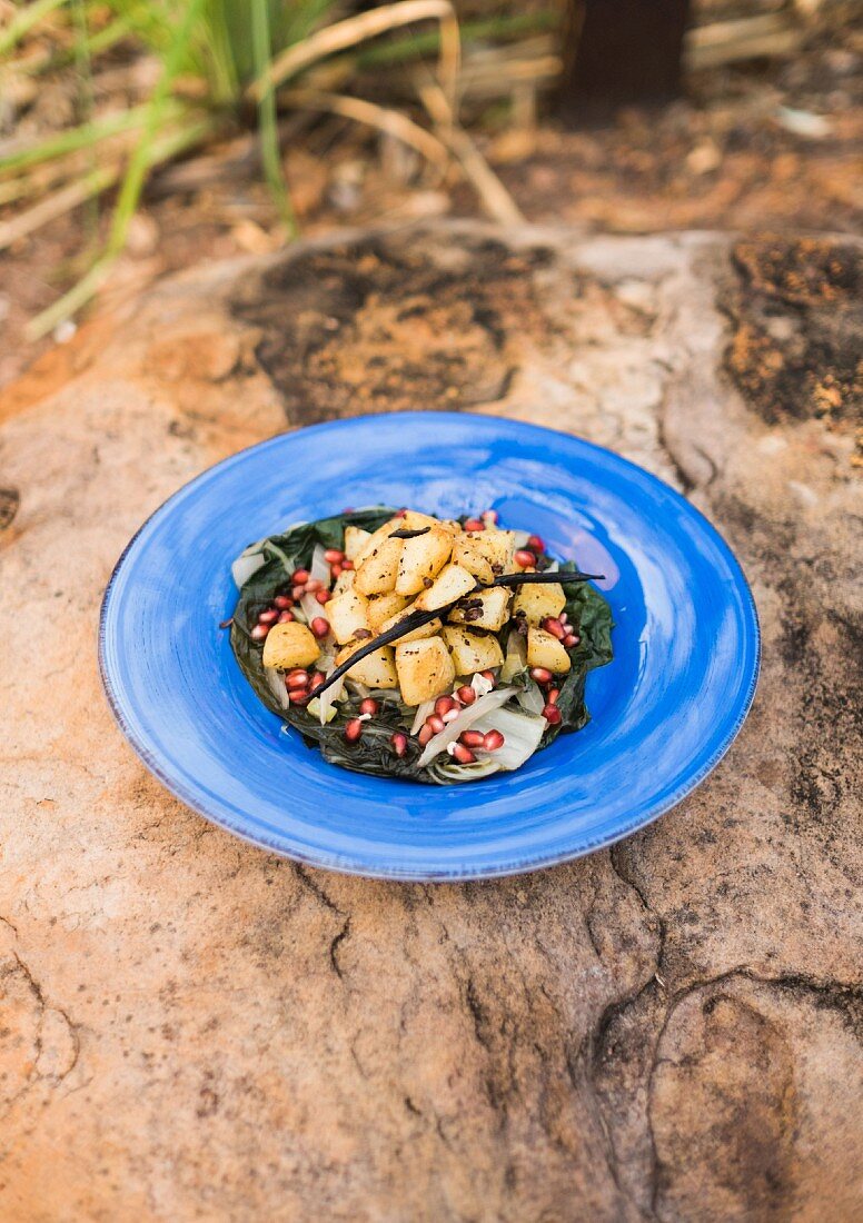 Vanilla and cocoa potatoes with stewed Swiss chard and pomegranate seeds