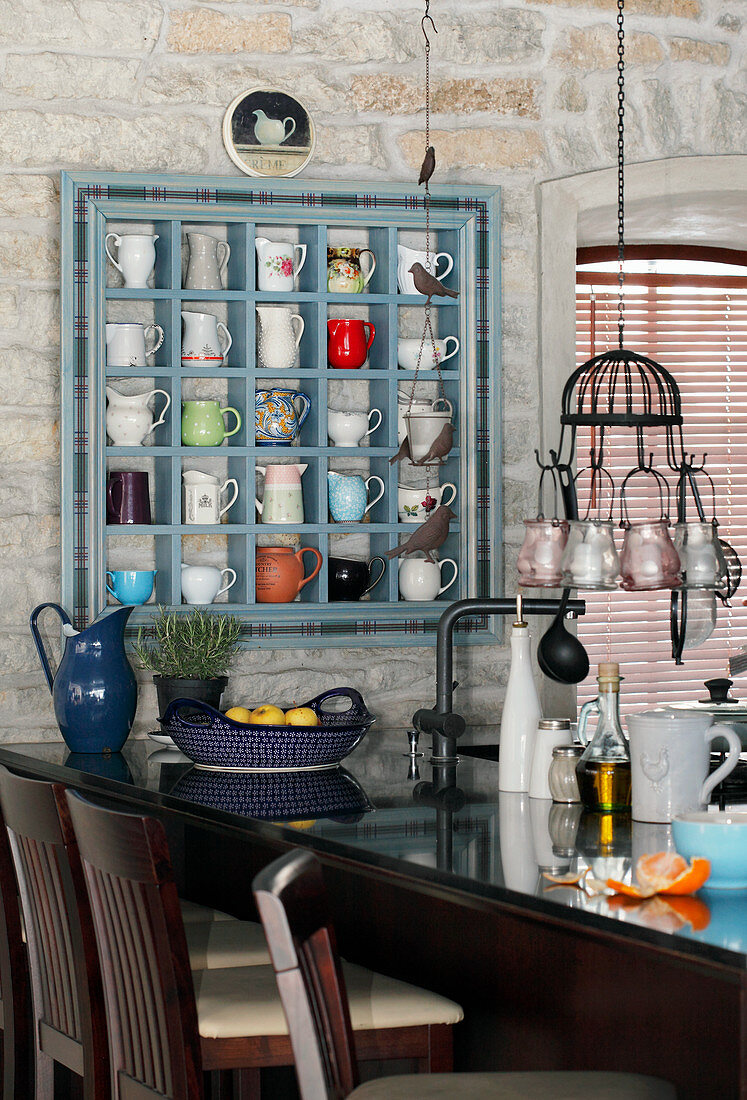 Milk jugs in blue display case above kitchen counter