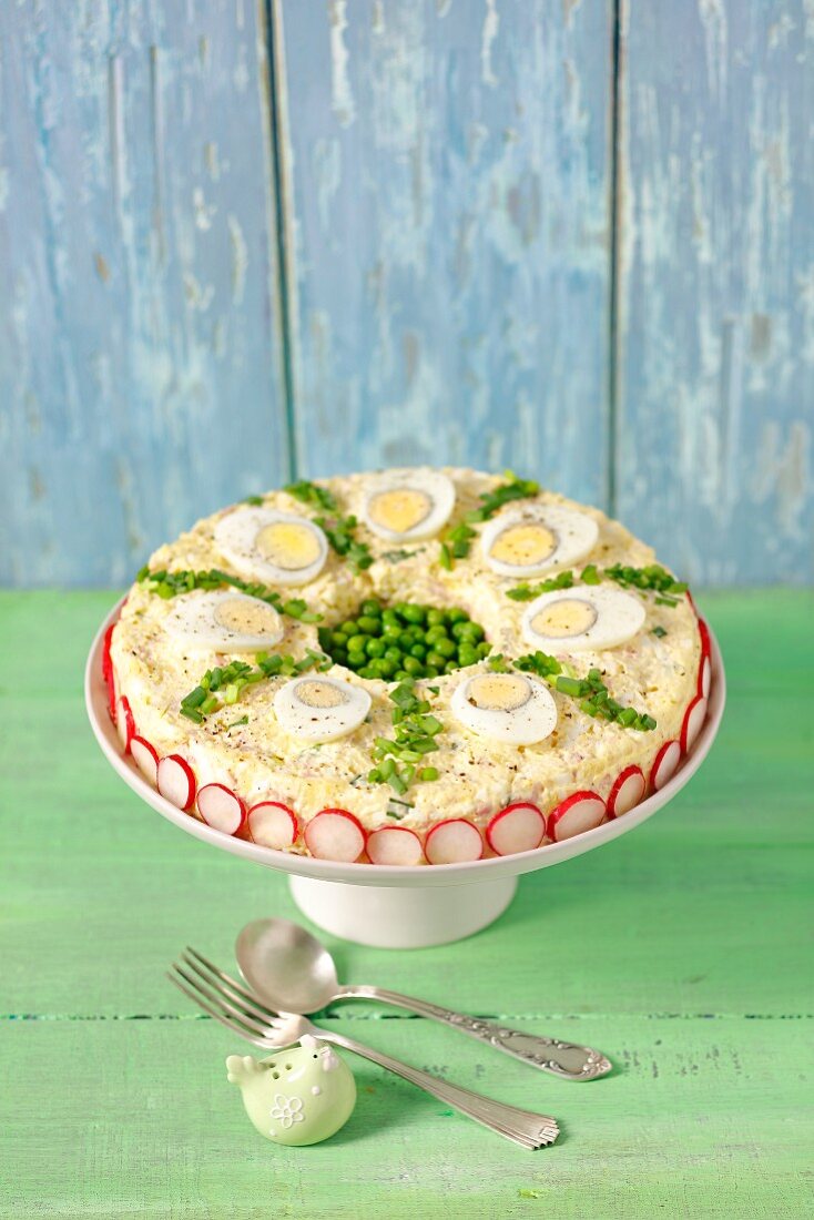 Egg salad with peas and mayonnaise, decorated like a pie