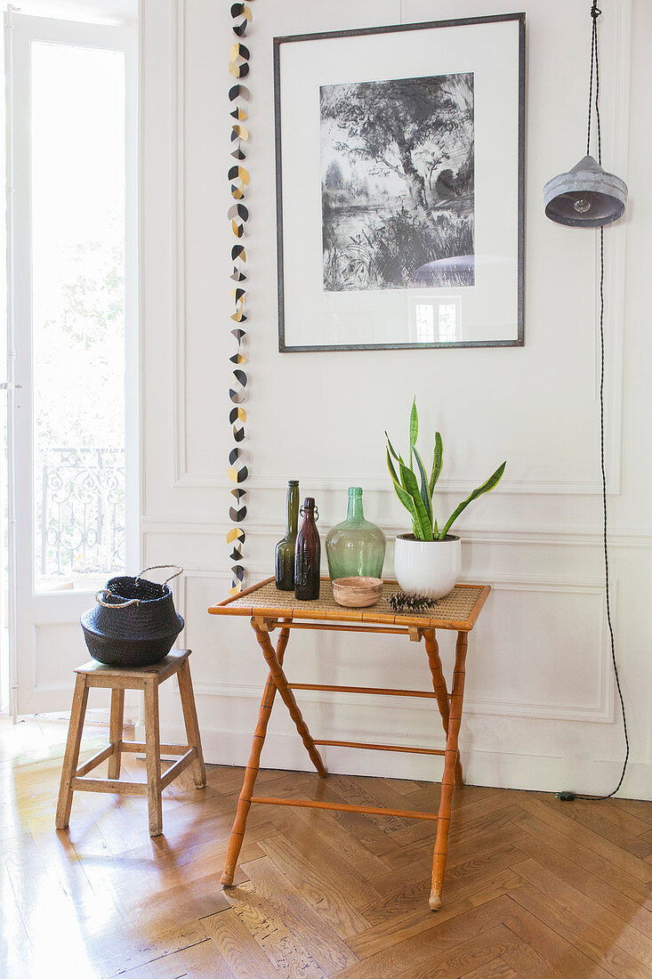 Folding table and stool against panelled wall