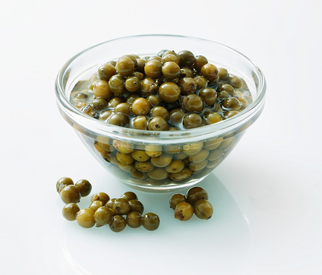 Pickled green peppercorns in a glass bowl