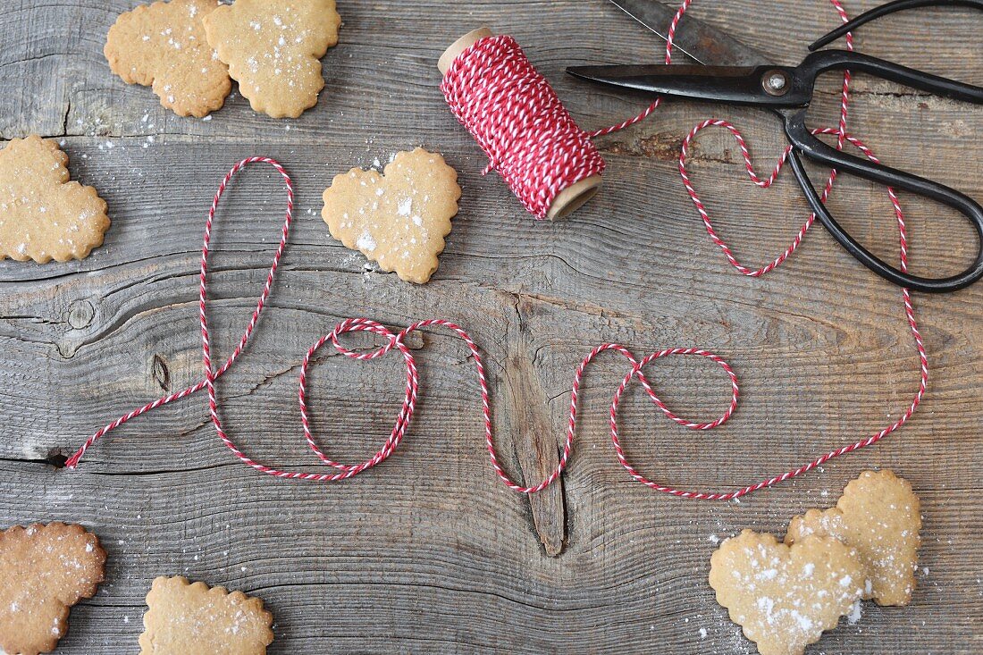 Heart shaped cookies and striped string spelling out the word 'love'