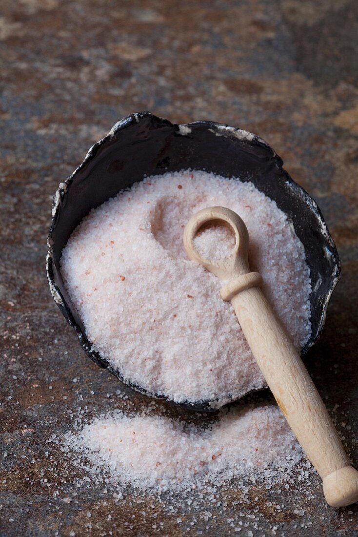 Fine Himalayan salt with a wooden spoon in a bowl