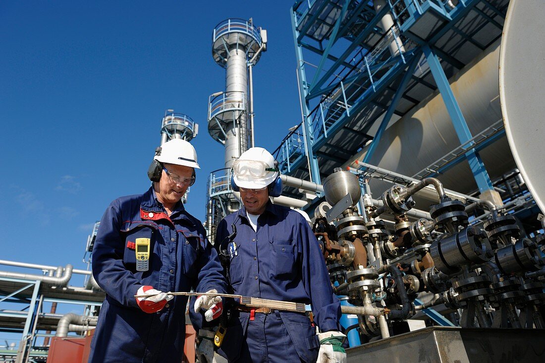 Oil refinery workers and pipework