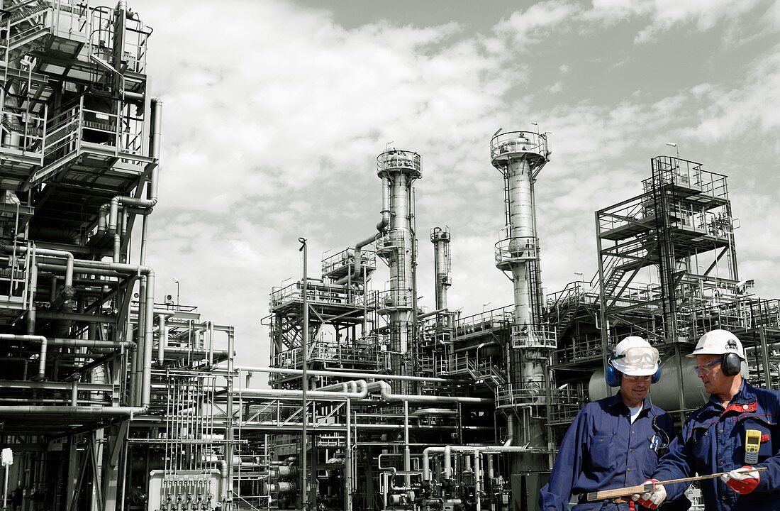 Oil refinery workers and pipework