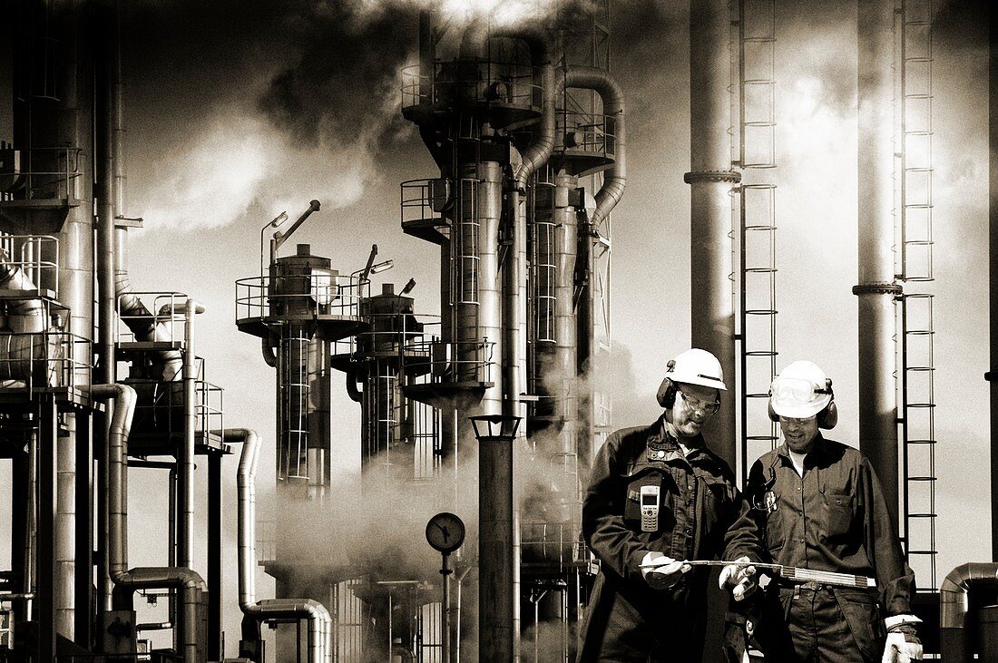 Oil refinery workers and pipework