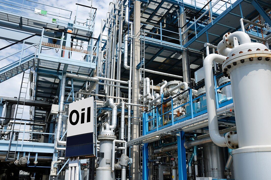 Oil refinery with pipework and sign