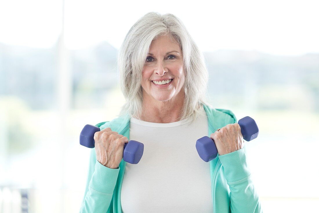 Senior woman using weights