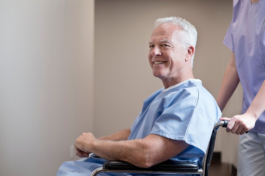 Man in hospital gown in wheelchair
