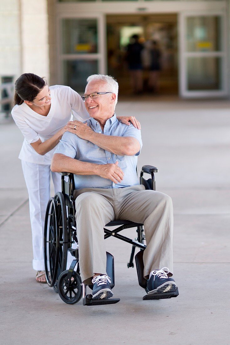 Senior man in wheelchair with care worker