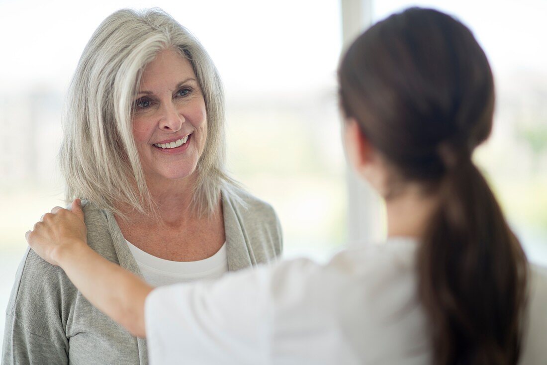 Senior woman talking to care worker