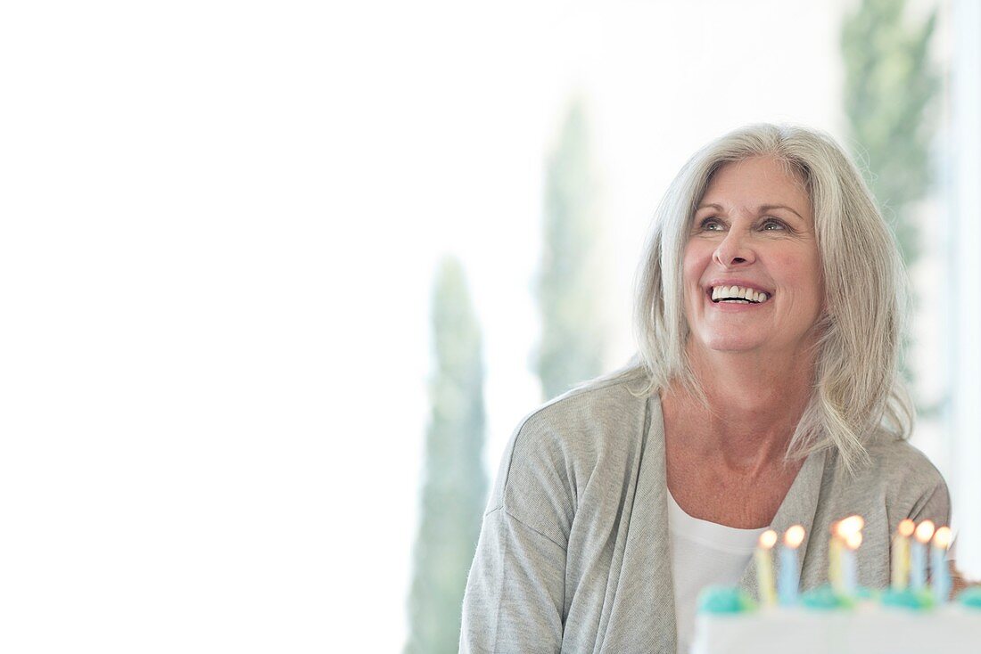 Senior woman with birthday cake