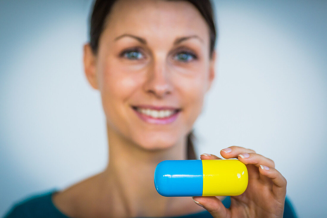 Woman holding capsule