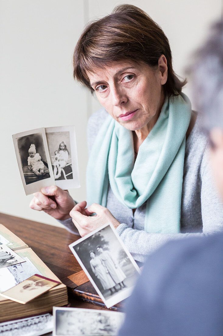 Senior woman looking at family photographs