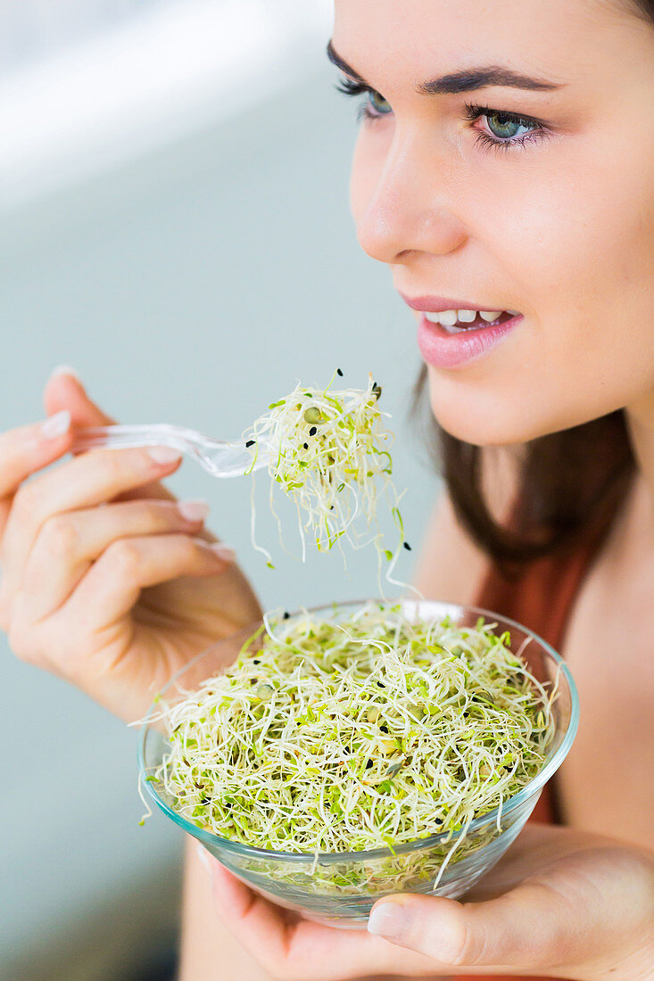 Woman eating sprouts