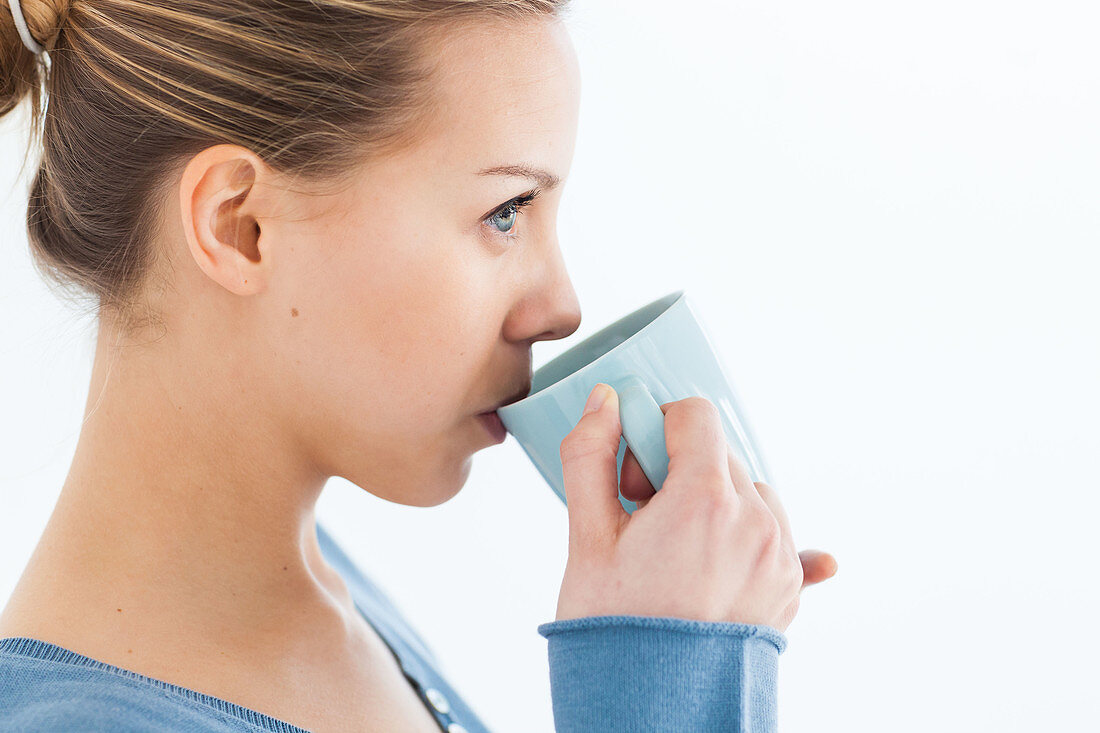 Woman drinking hot beverage