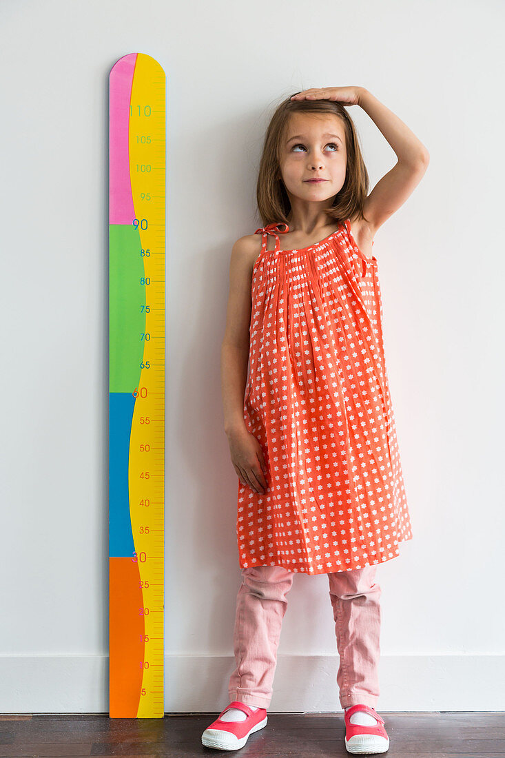 5-year-old girl measuring herself