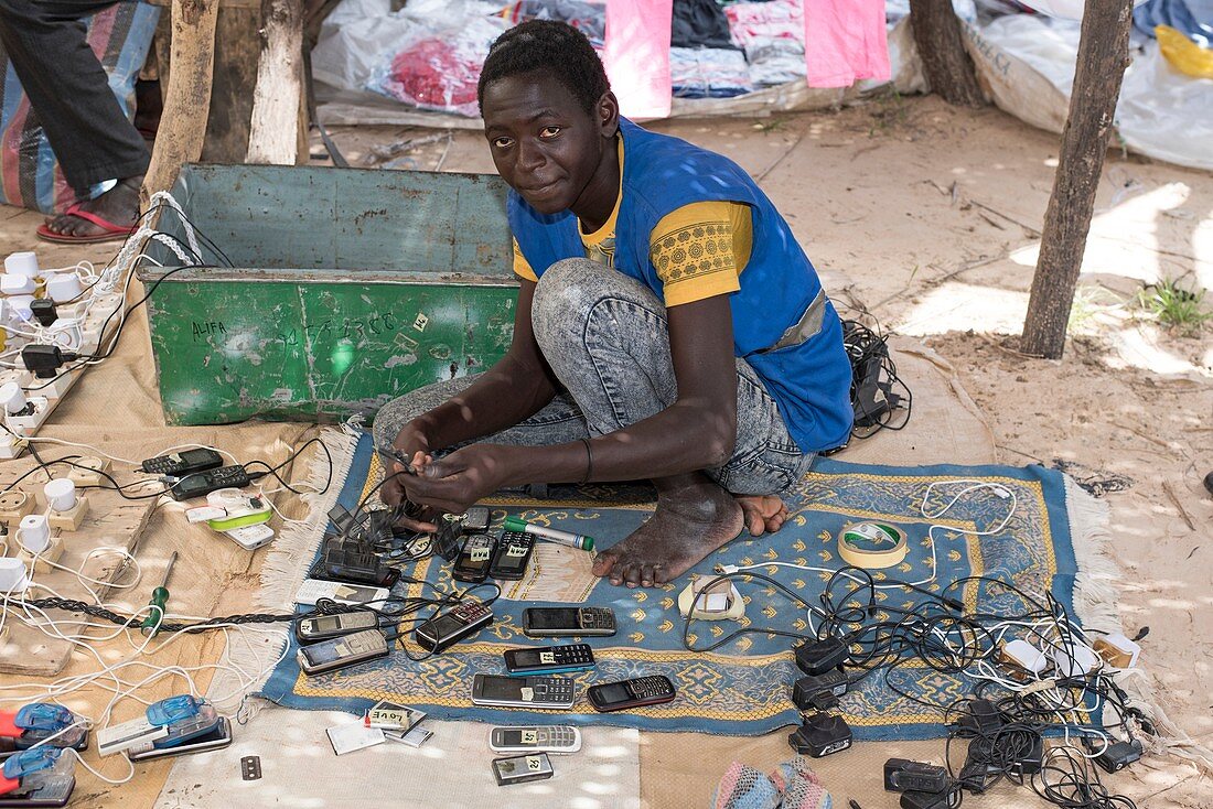 Cell phone repairman in a market in Chad