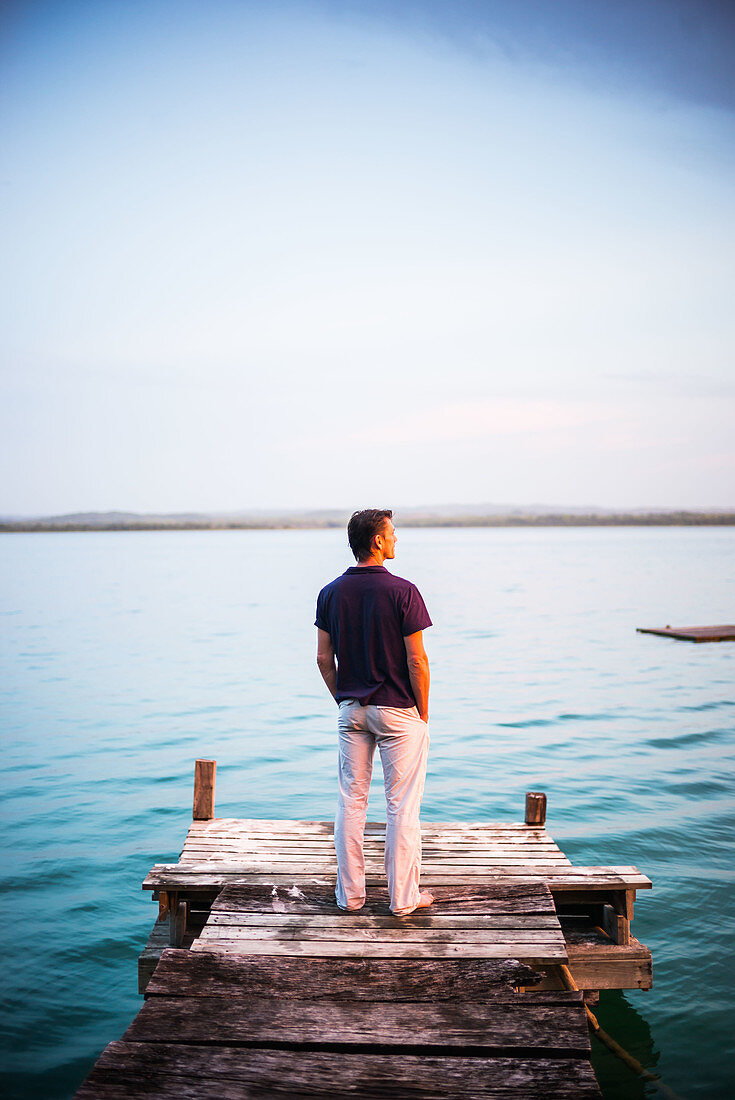 Man standing on lakeside