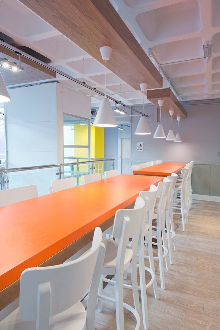 Orange tables in industrial-style canteen