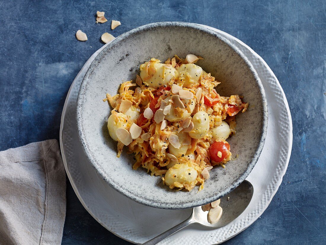 Carrot gnocchi with cherry tomatoes and almond flakes