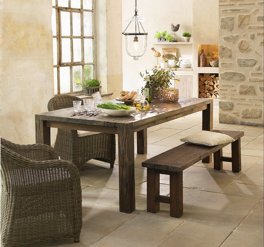 Rustic dining area in country-house kitchen with stone floor and Mediterranean ambiance