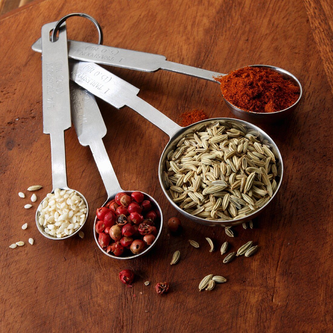 Spices and sesame seeds in measuring spoons