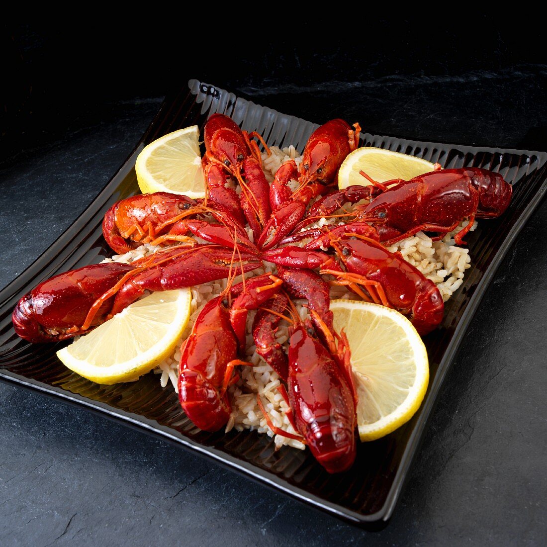 Cooked crayfish with lemons on wild rice