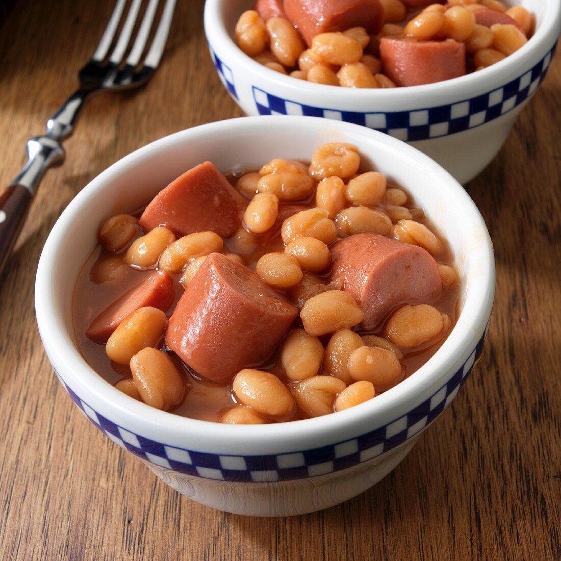 Frankfurters with baked beans in two serving bowls