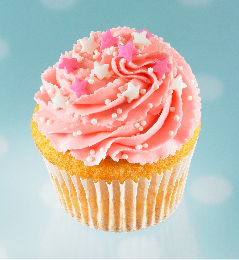 Cupcake with pink icing and sugar decorations