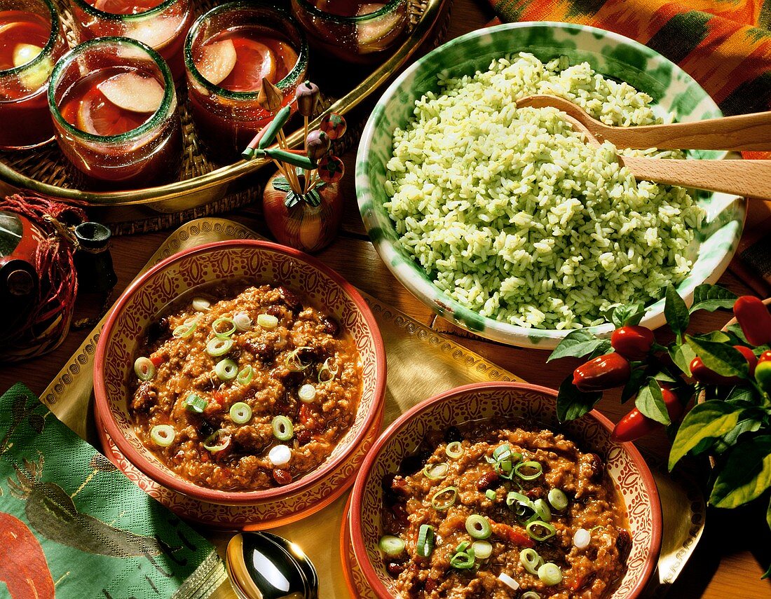 Two Bowls of Chili con Carne and a Bowl of Green Pepper Rice