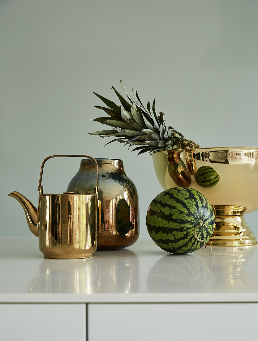Gold kettle, vase and bowl with pineapple and watermelon