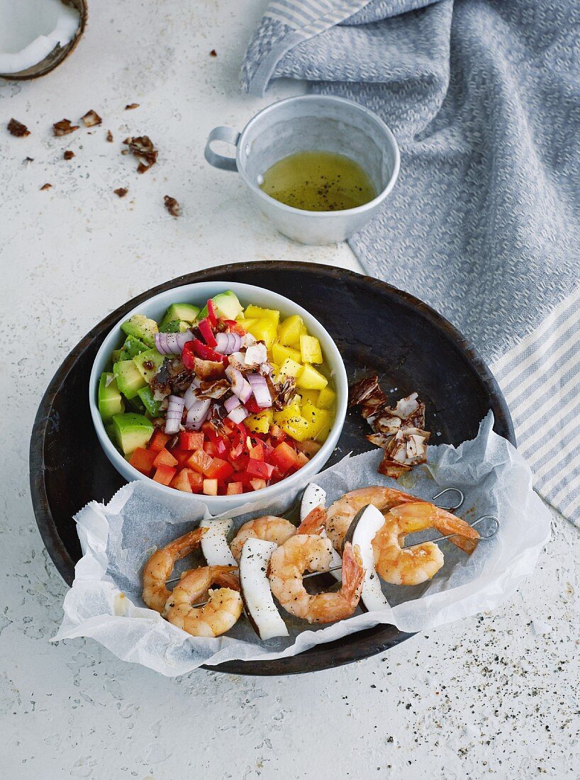 Rainbow Caribbean salad with prawn and coconut skewers