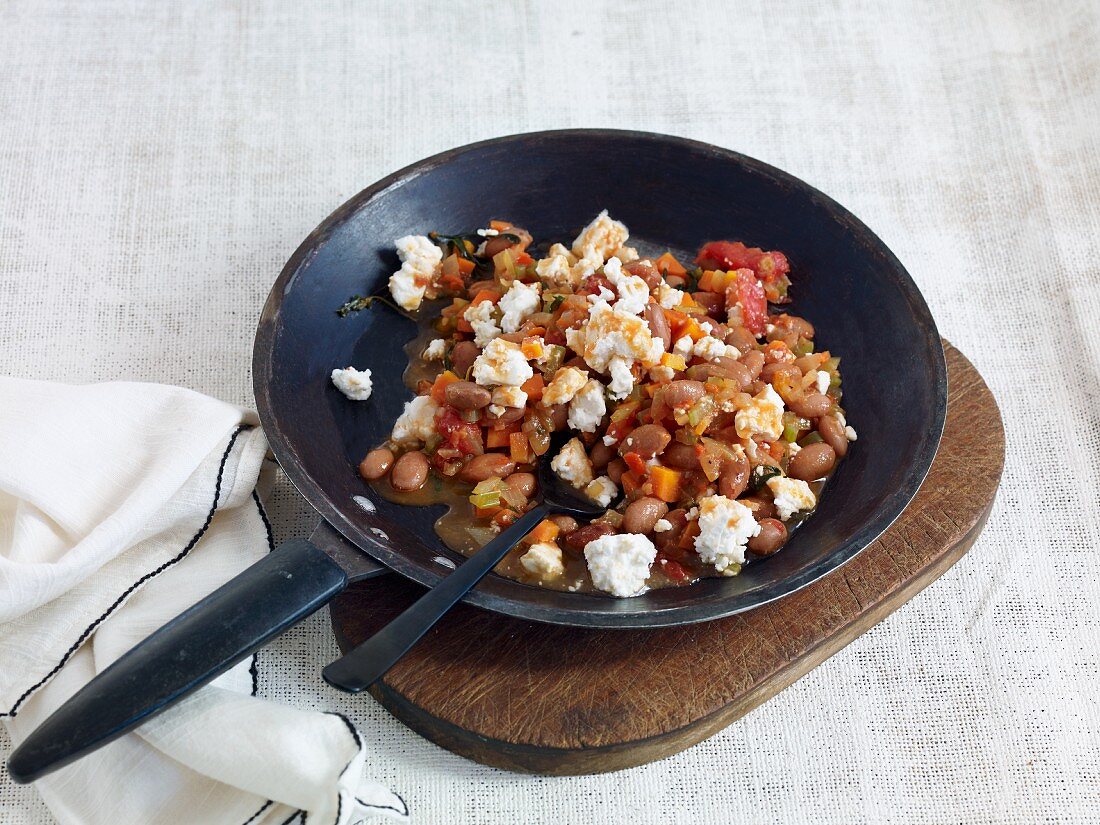 Bean chilli with feta served in a pan