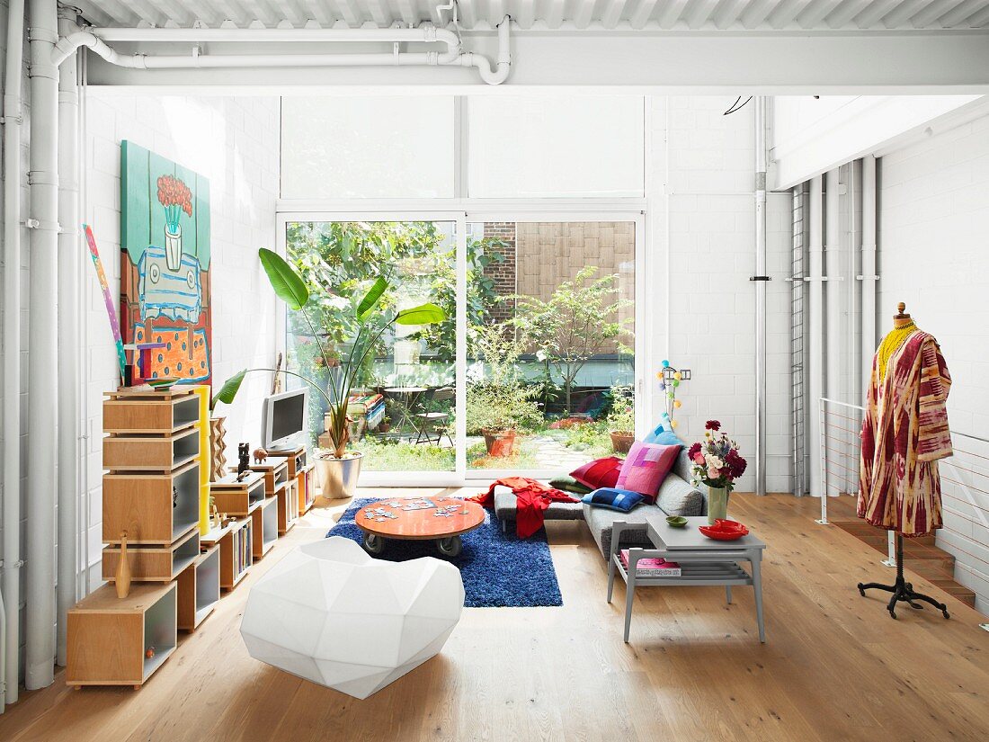 Modular shelves, designer chair and tailors' dummy in living room