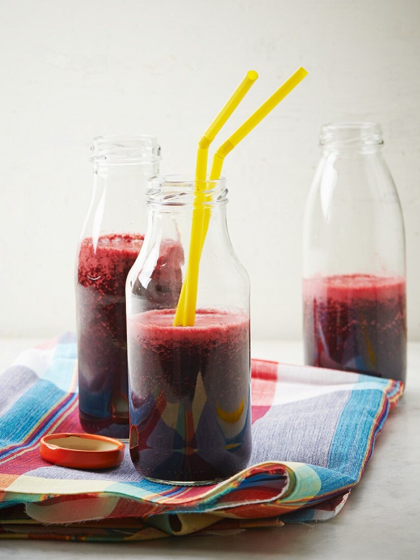 Blueberry and beetroot smoothies in bottles