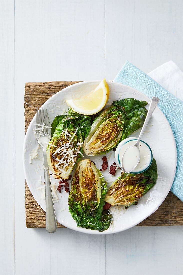 Grilled romaine lettuce with bacon, parmesan and a Caesar dressing