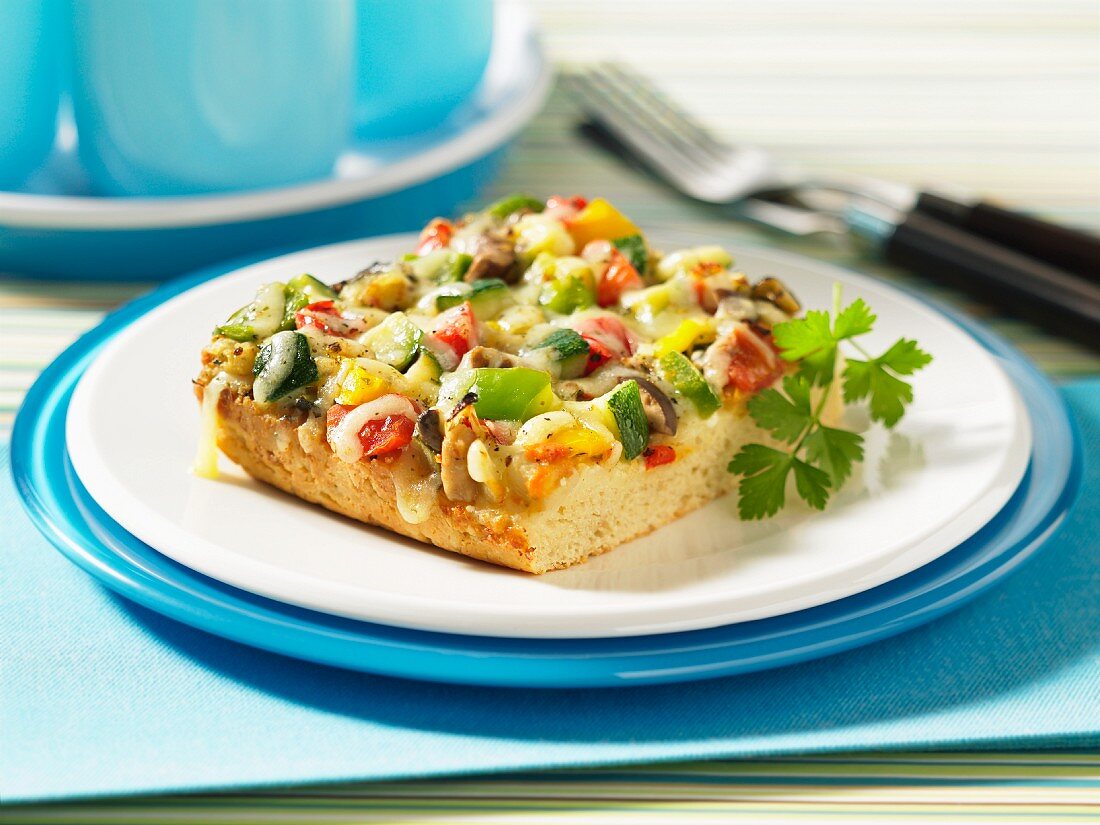 A slice of vegetable pizza with cheese