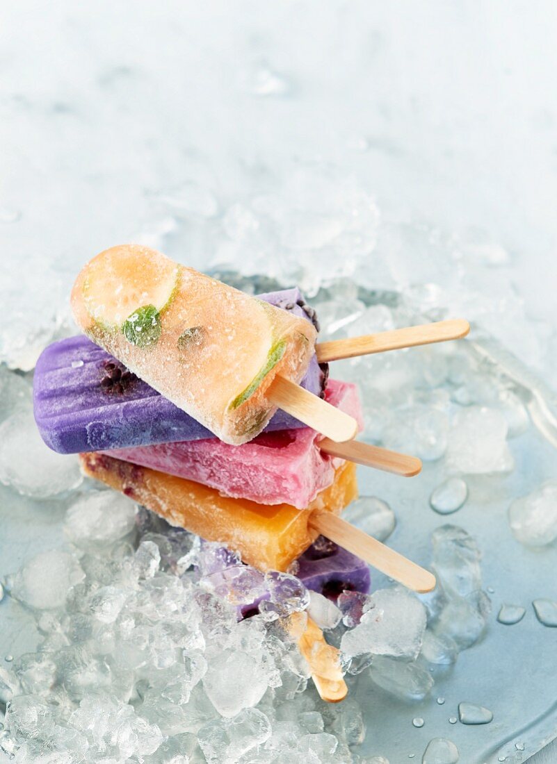 Various ice lollies on crushed ice