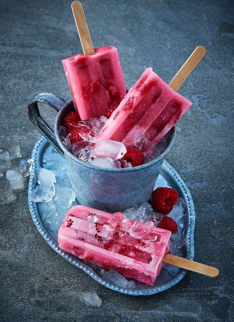 Raspberry ice lollies on crushed ice