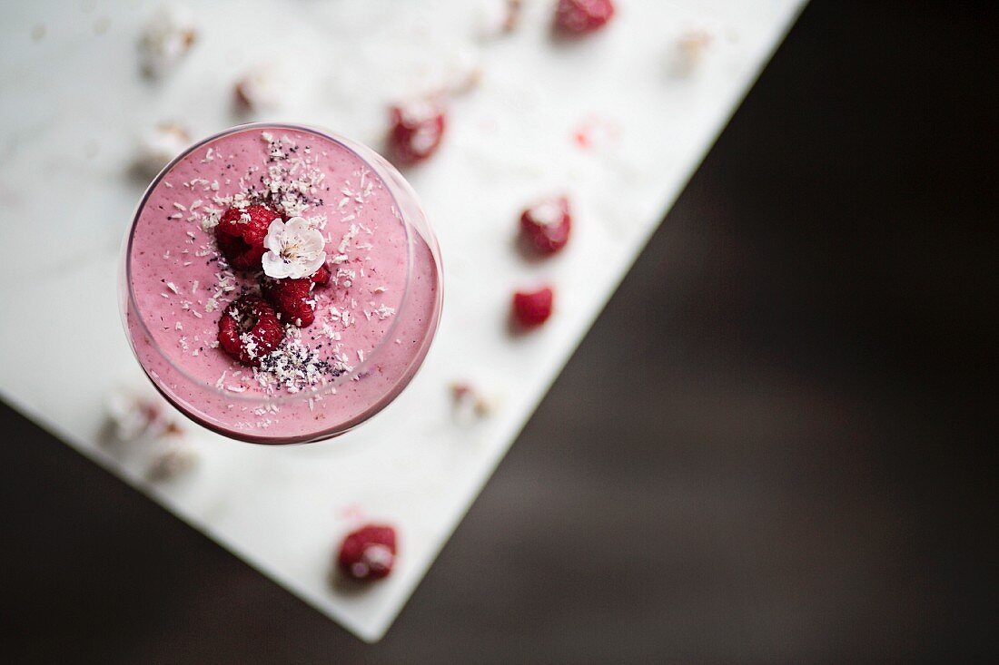 Raspberry smoothie on white table