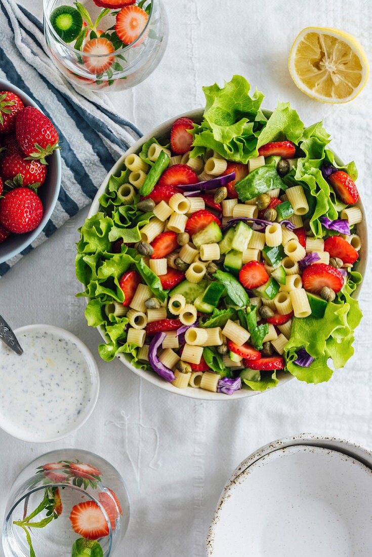 Strawberry Pasta Salad with herbs and cucumber in a bowl