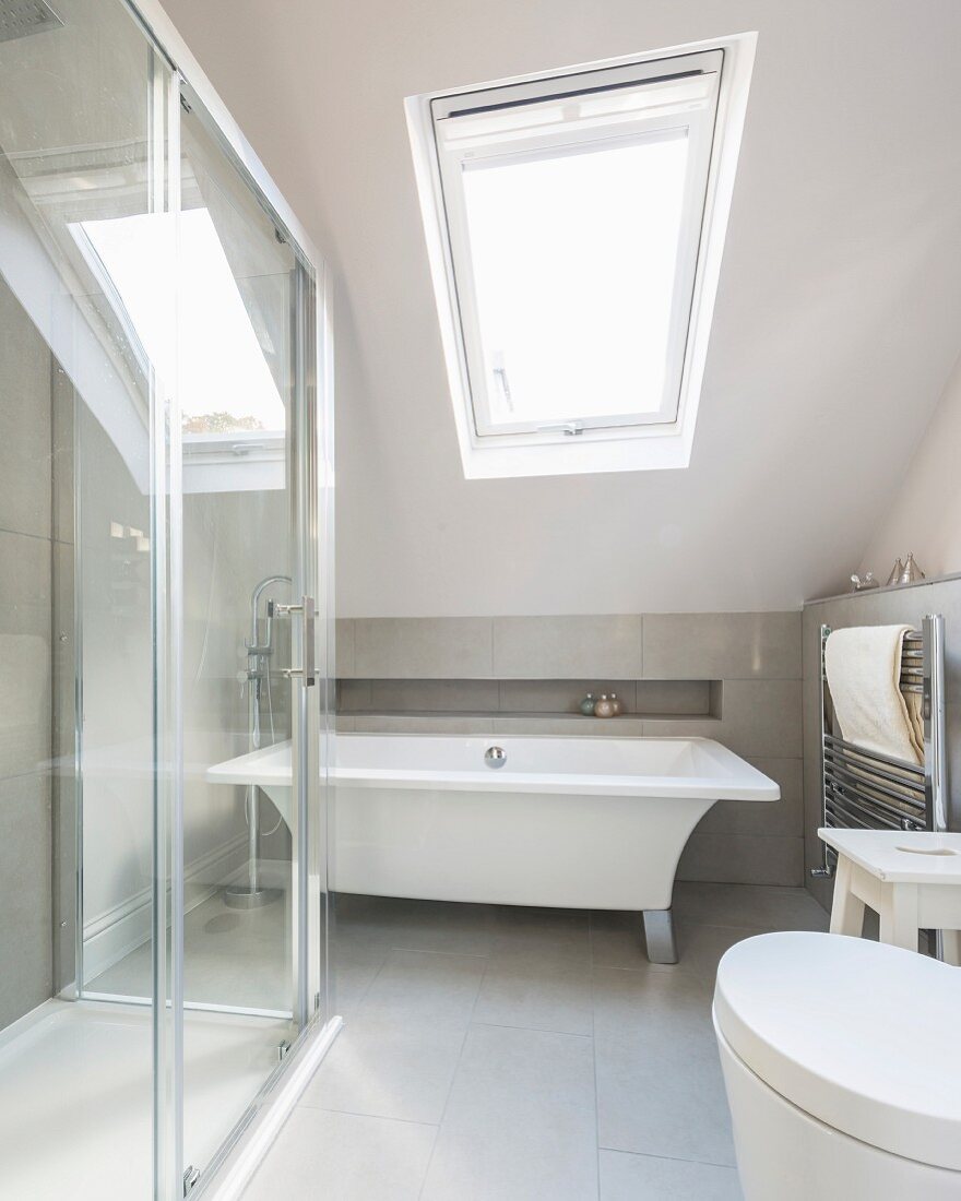 Modern free-standing bathtub in attic bedroom