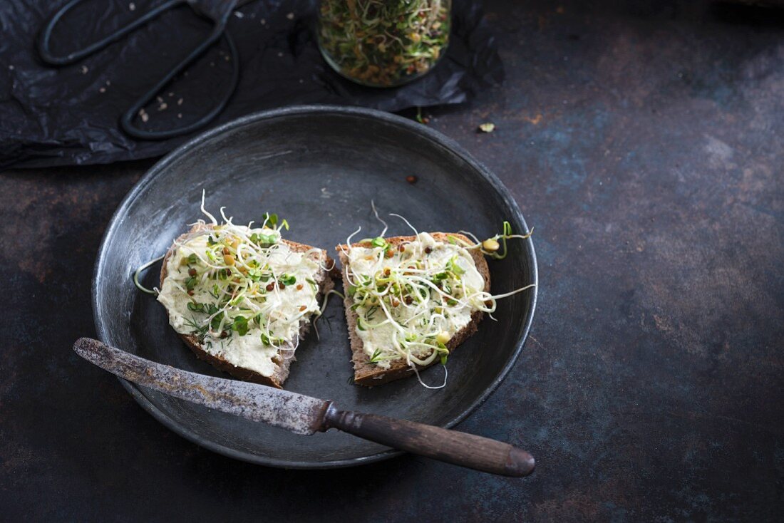Bread with a cashew spread and fresh sprouts (vegan)